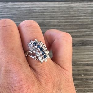 Silver tone ring with blue and white stones